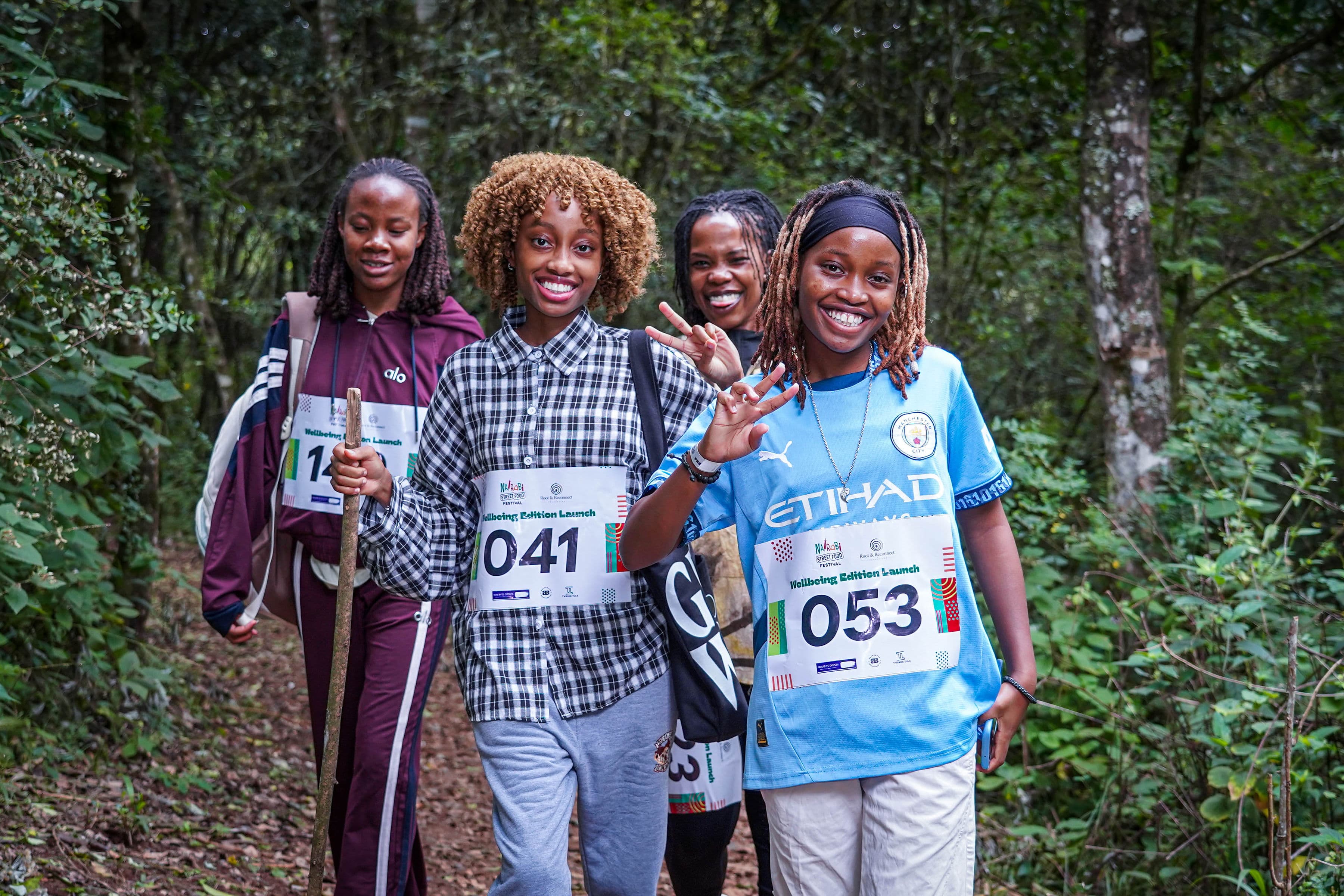 Four participants walking a forest trail at the Wellbeing Edition Launch