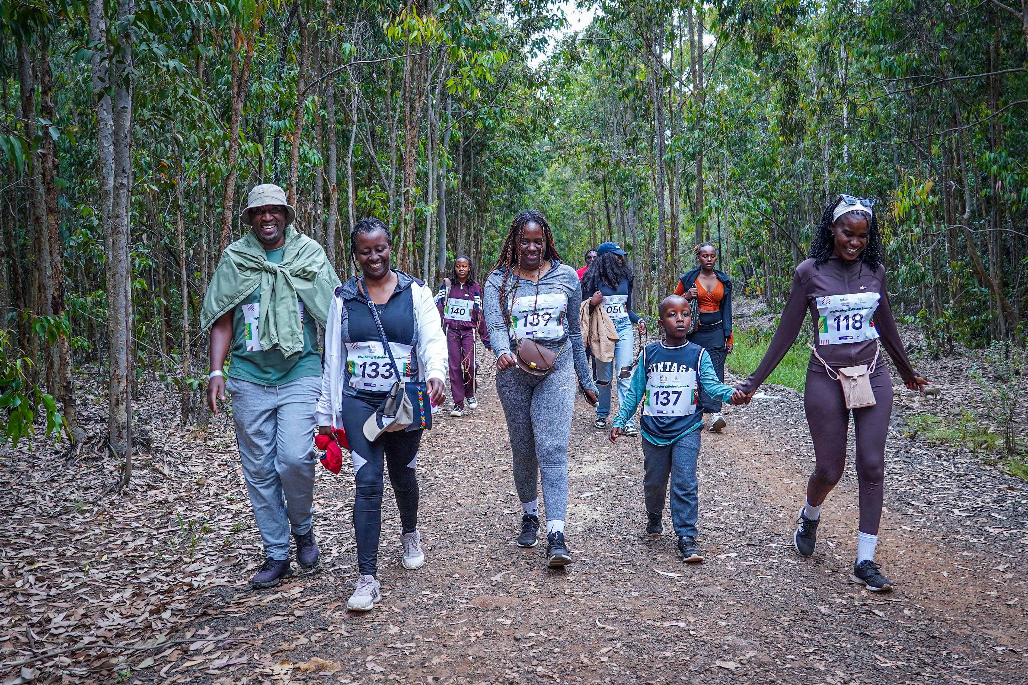 A group walking together through a forest at the Wellbeing Edition Launch