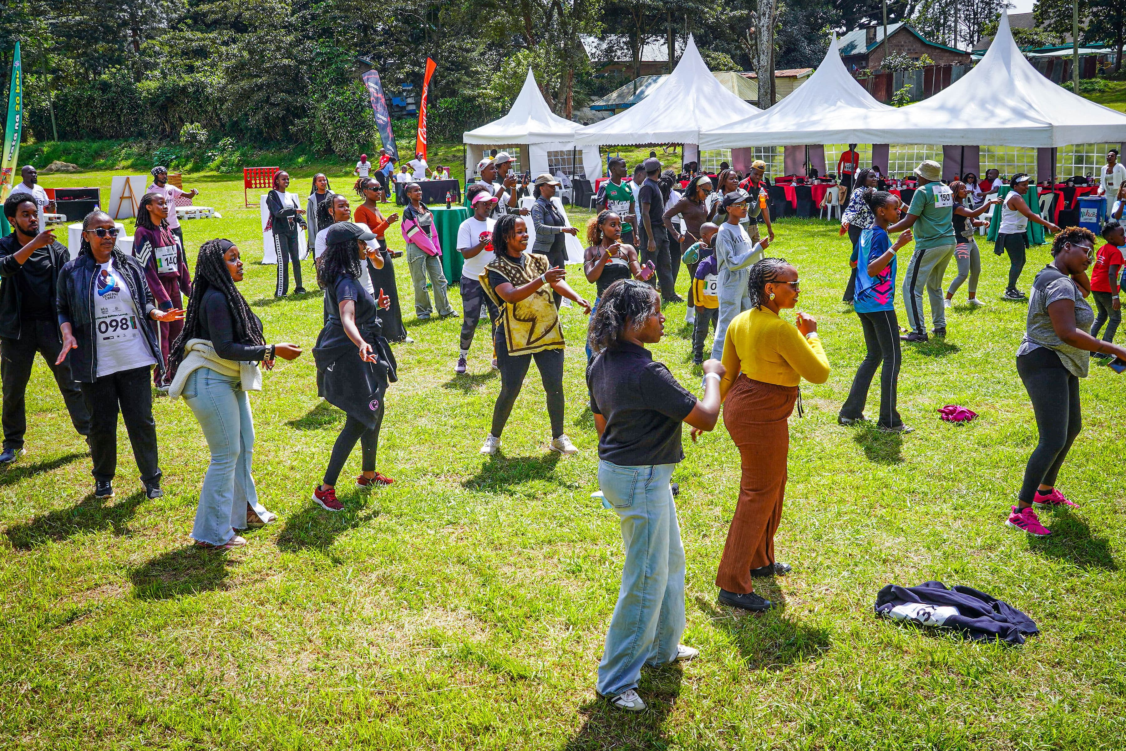 A crowd dancing together on the grass at the Wellbeing Edition Launch