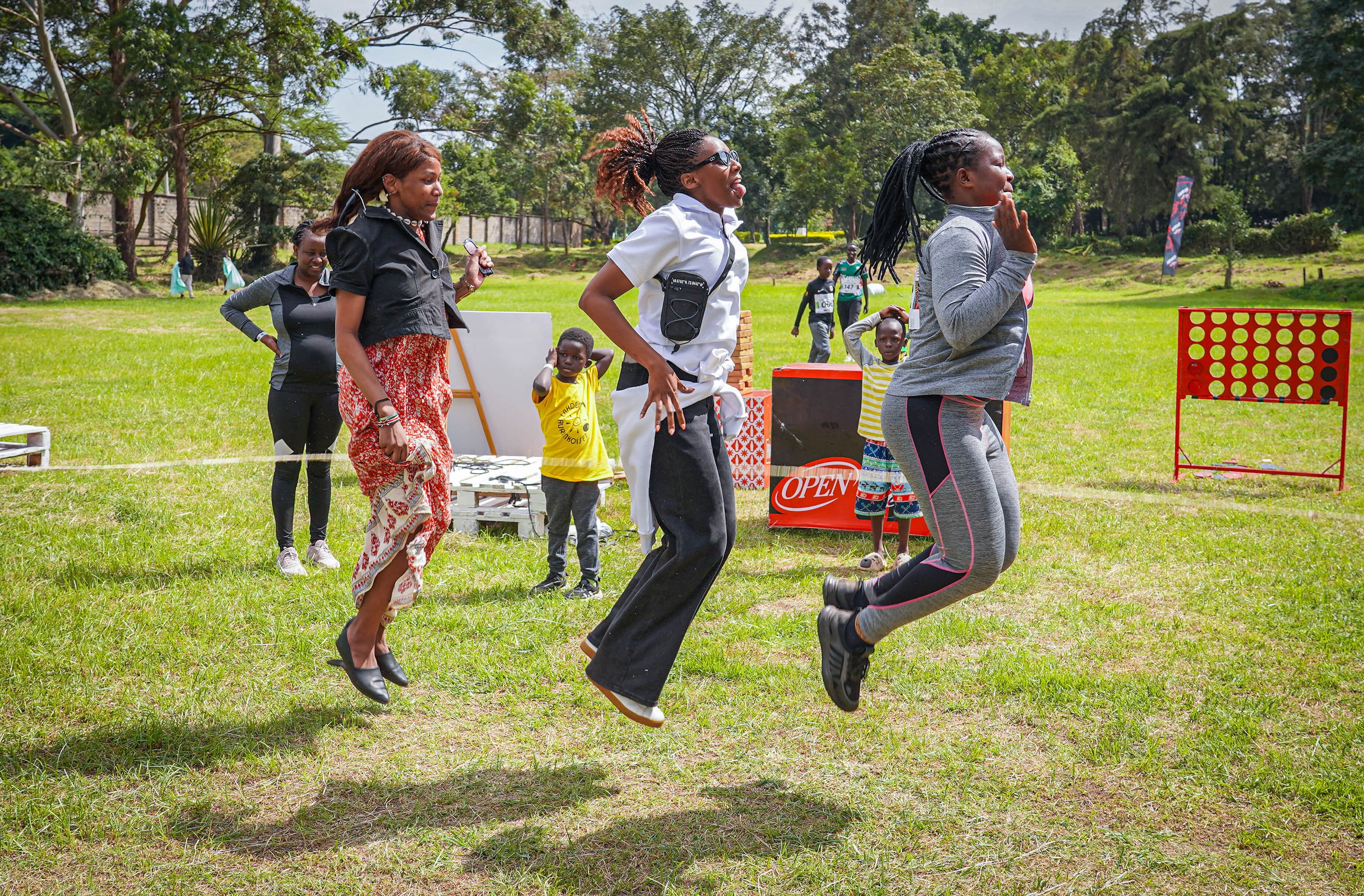 Attendees dancing and playing together on the grass
