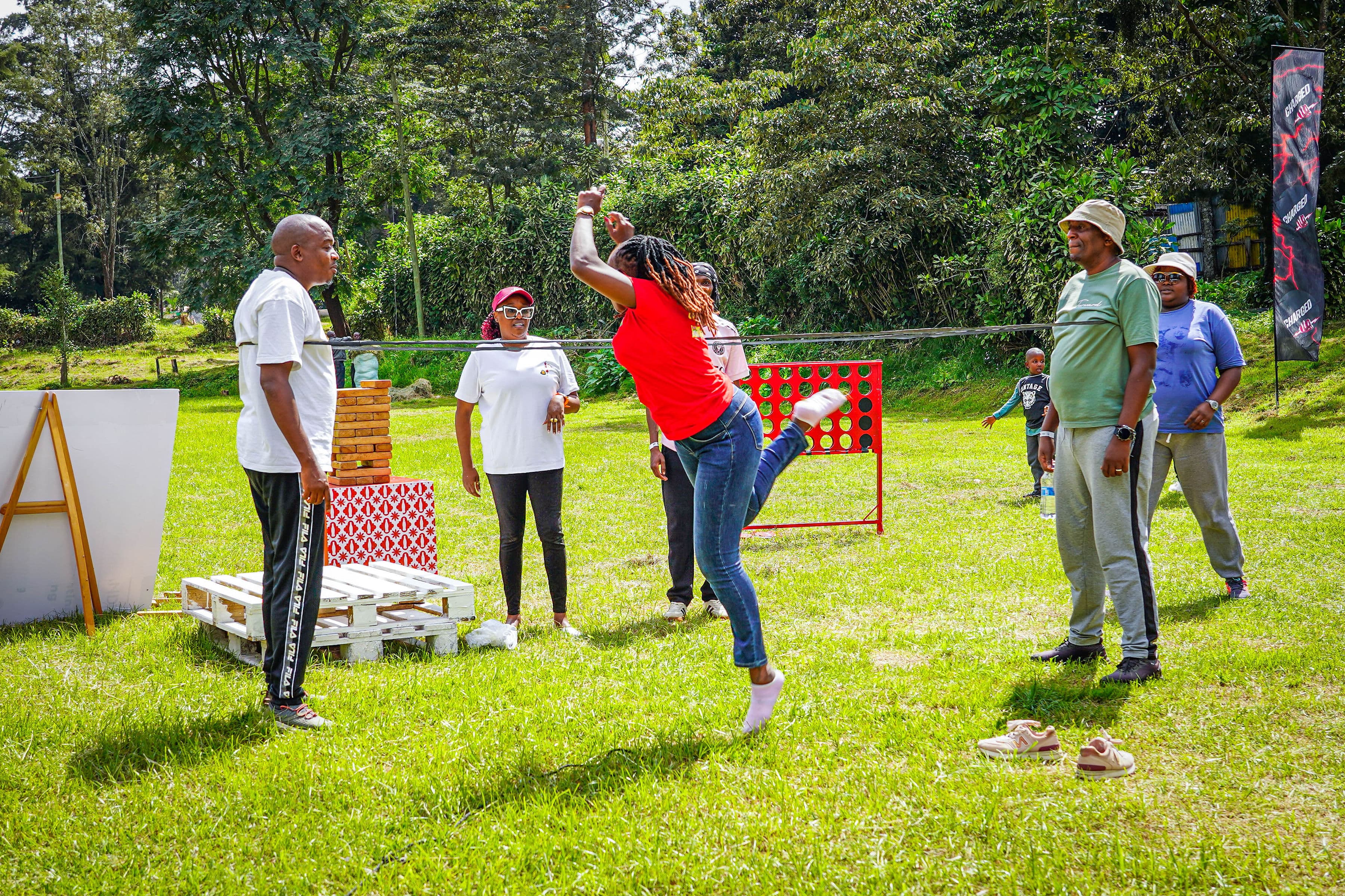 A participant kicking a leg high during a team game on the grass
